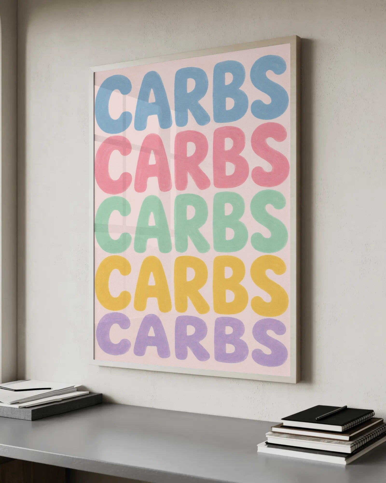 Typography art print with the word CARBS repeated five times down the page in bold gouache bubble lettering, each line in blue, pink, green, yellow or purple on a pink background.