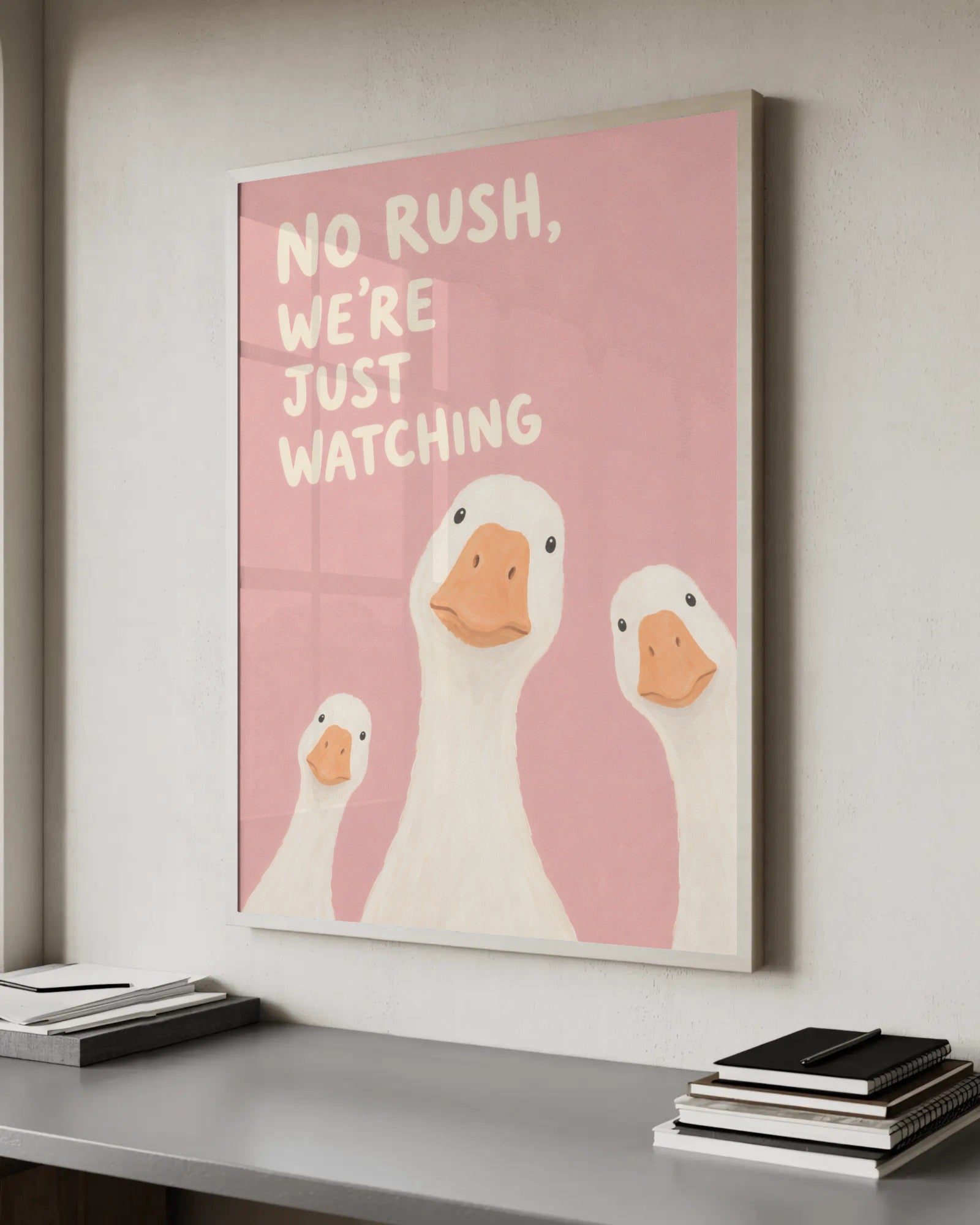 Soft painterly illustration of three white ducks peering up at the viewer on a pink background, with the caption "No rush, we're just watching".