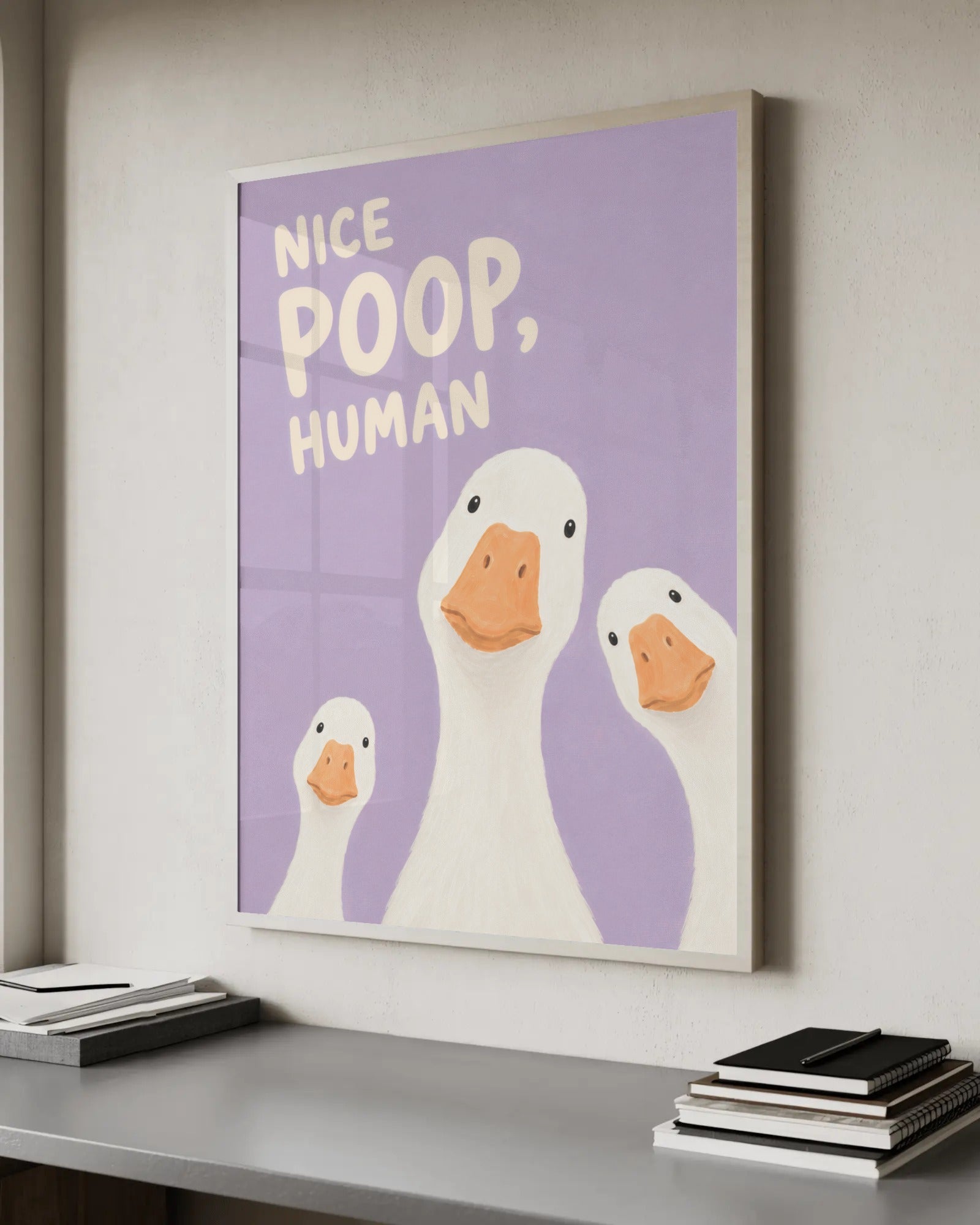 Soft painterly illustration of three white ducks looking up at the viewer on a lilac background, with the words "Nice poop, human" in matching lettering.