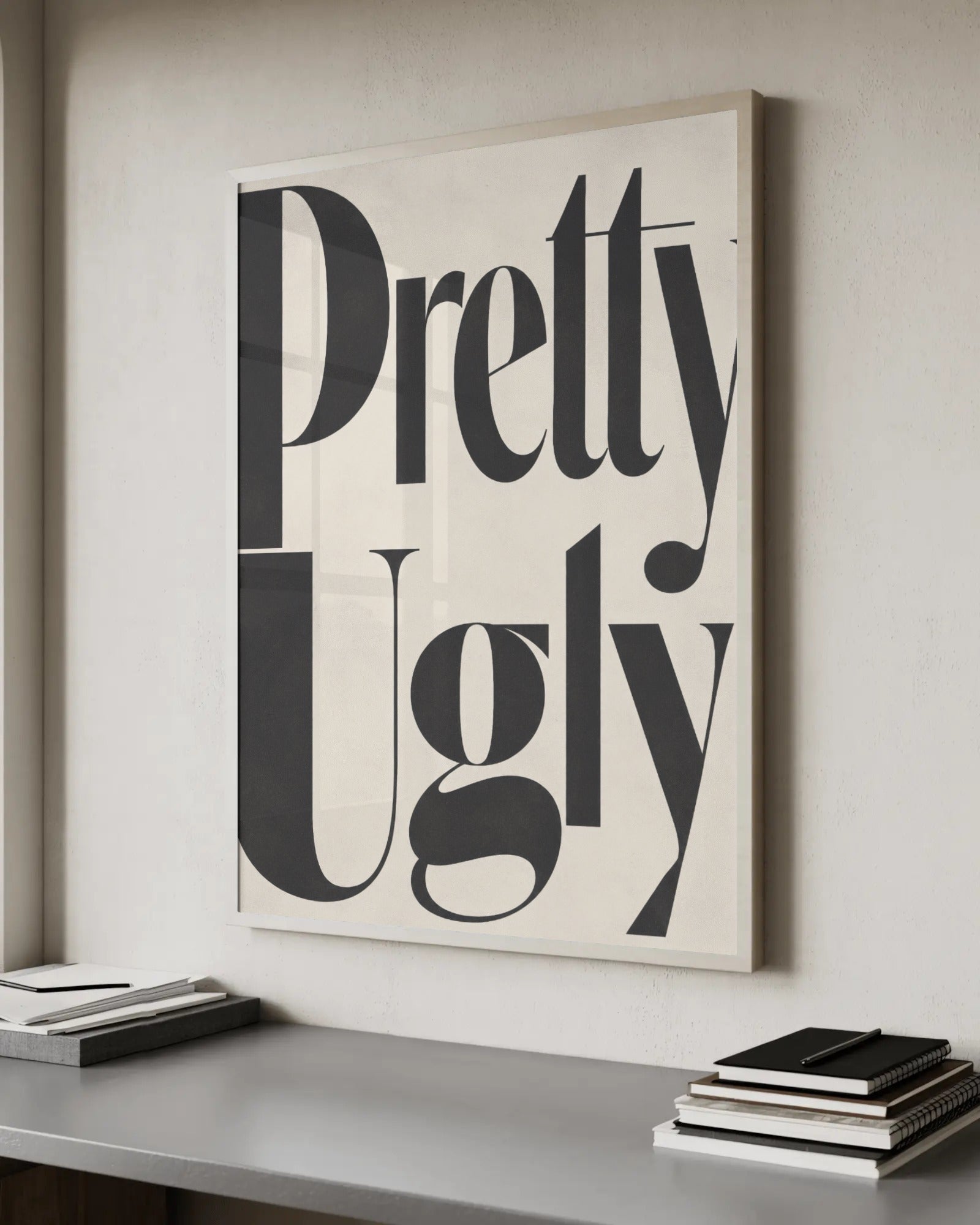 Editorial serif typography reading Pretty Ugly in black lettering on a cream background, glossy magazine style